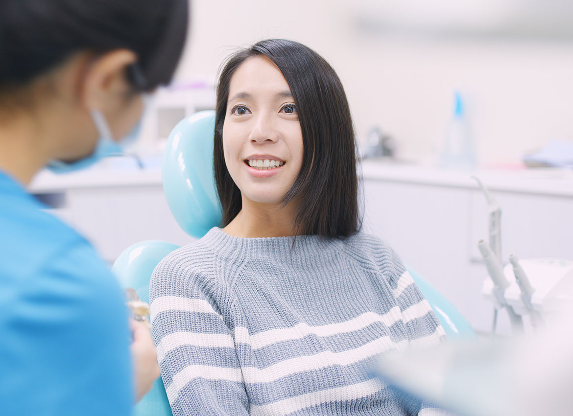 patient showing her teeth to the dentist